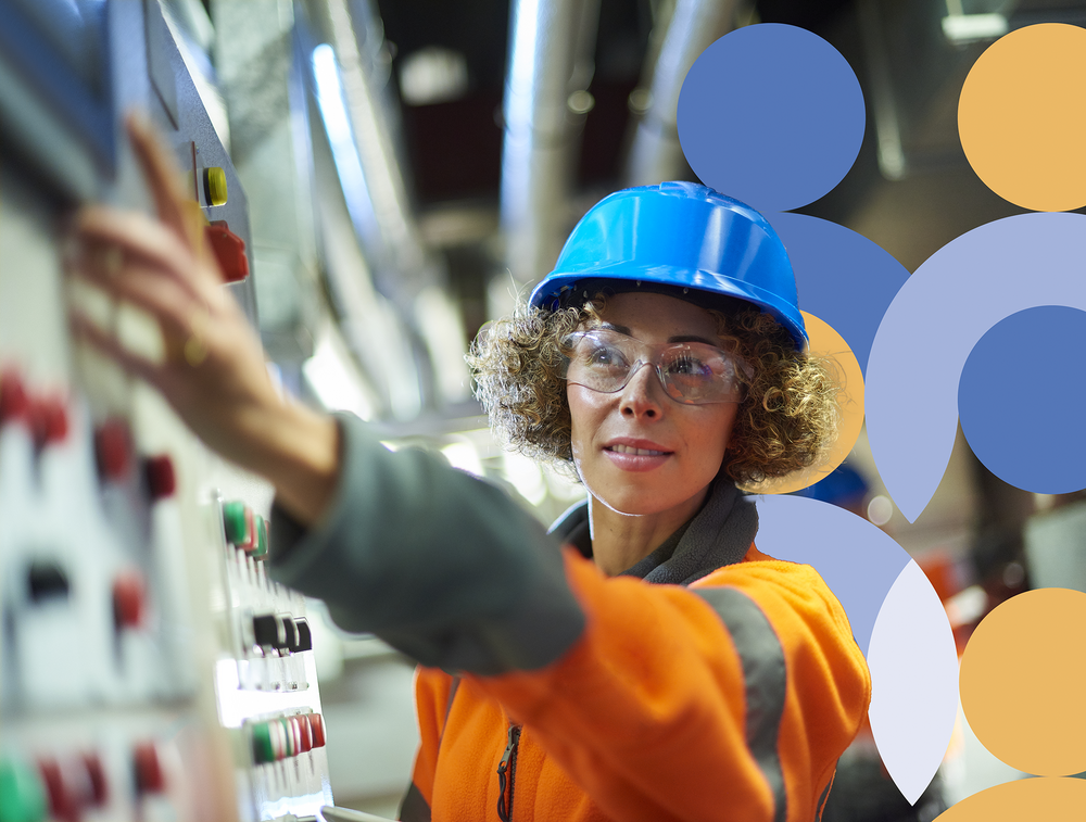 A leader working with a colleague in an industrial setting